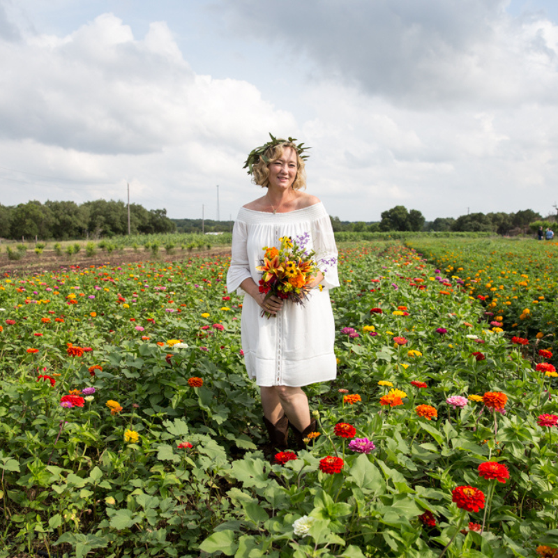 Woman standing in flower field